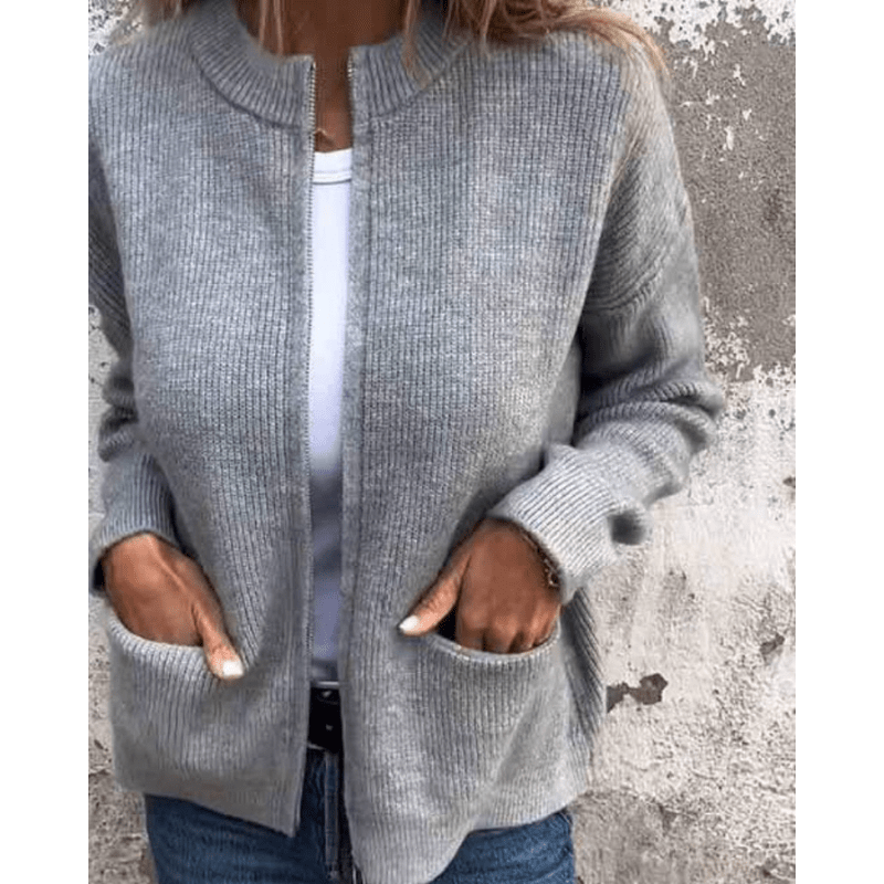 Grey ribbed knit cardigan with a relaxed open-front, collarless neckline, and two deep patch pockets.