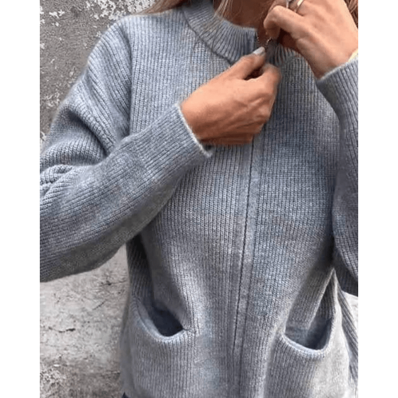 Grey ribbed knit cardigan with a collarless neckline, relaxed fit, and deep front patch pockets.