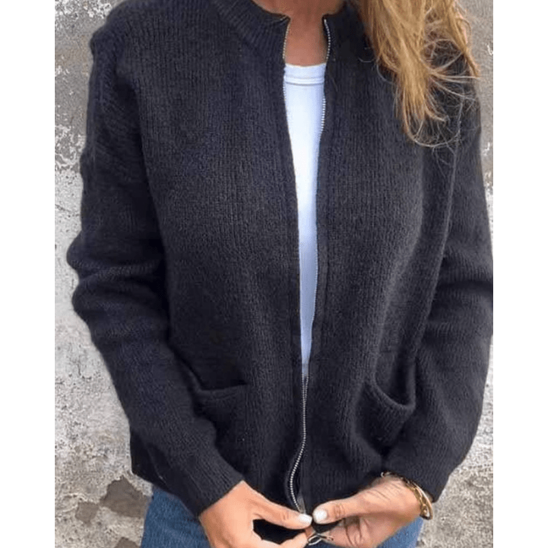 Black ribbed knit cardigan with a zip-front closure, patch pockets, and a relaxed, collarless silhouette.