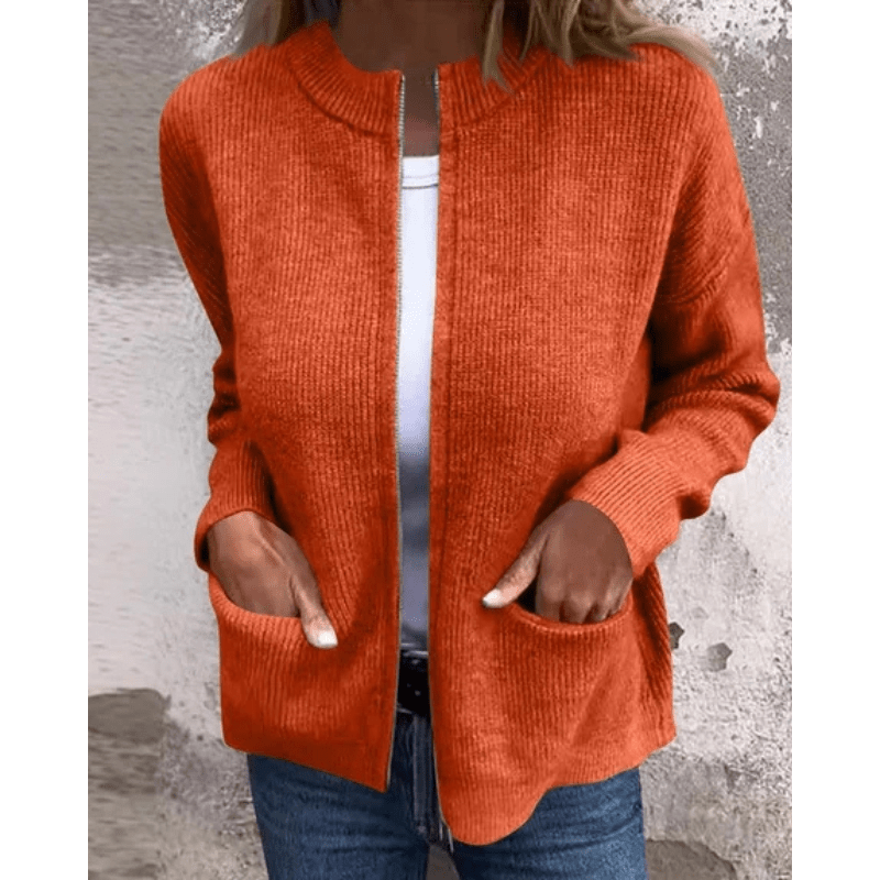 Burnt orange ribbed knit cardigan with a relaxed open-front silhouette, collarless neckline, and deep patch pockets.