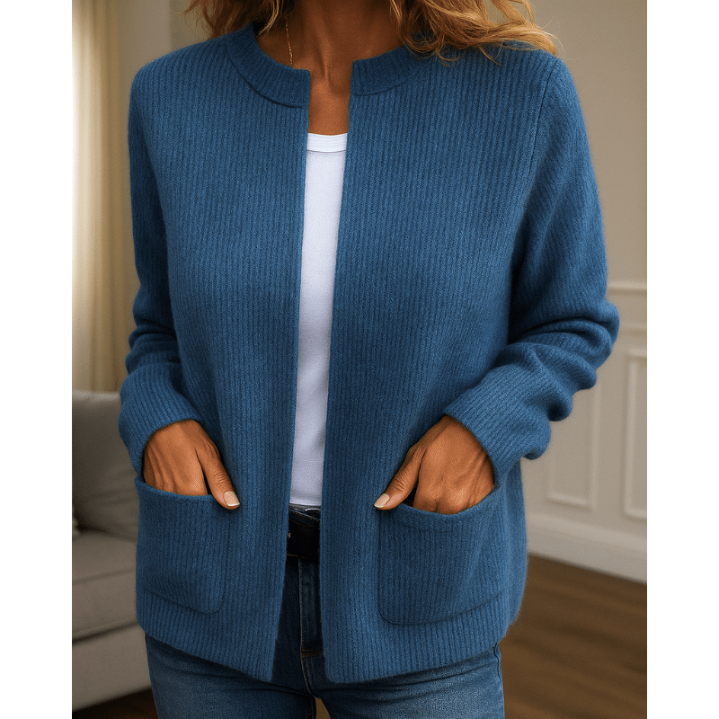 Blue ribbed knit cardigan with an open-front, collarless neckline and two patch pockets in a relaxed fit.