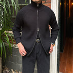 Black ribbed cotton-blend zip-up cardigan with a stand collar and slim-fit silhouette worn over dark trousers.