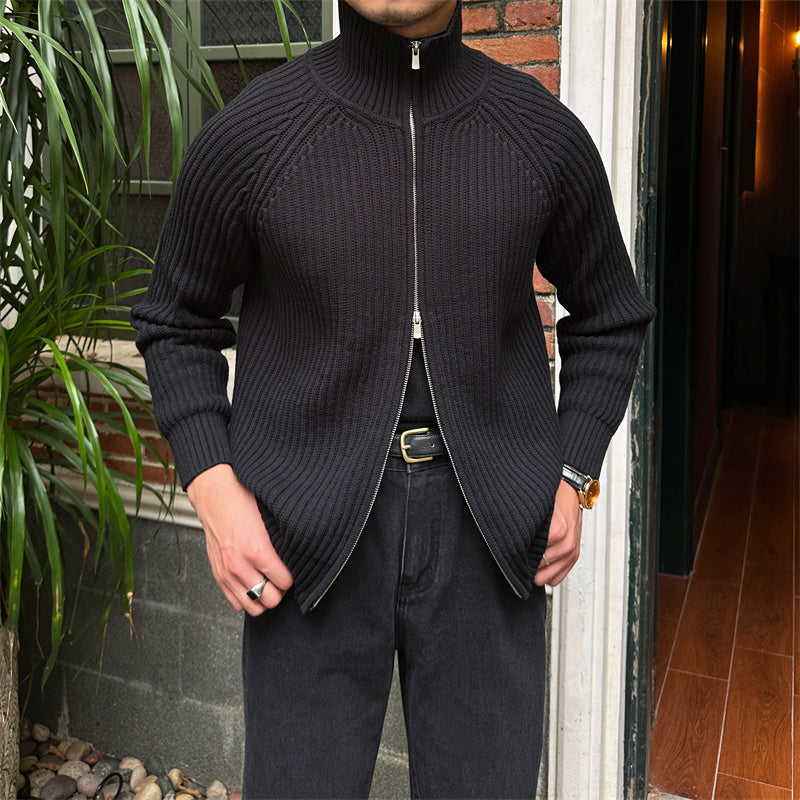 Black ribbed cotton-blend zip-up cardigan with a stand collar and slim-fit silhouette worn over dark trousers.
