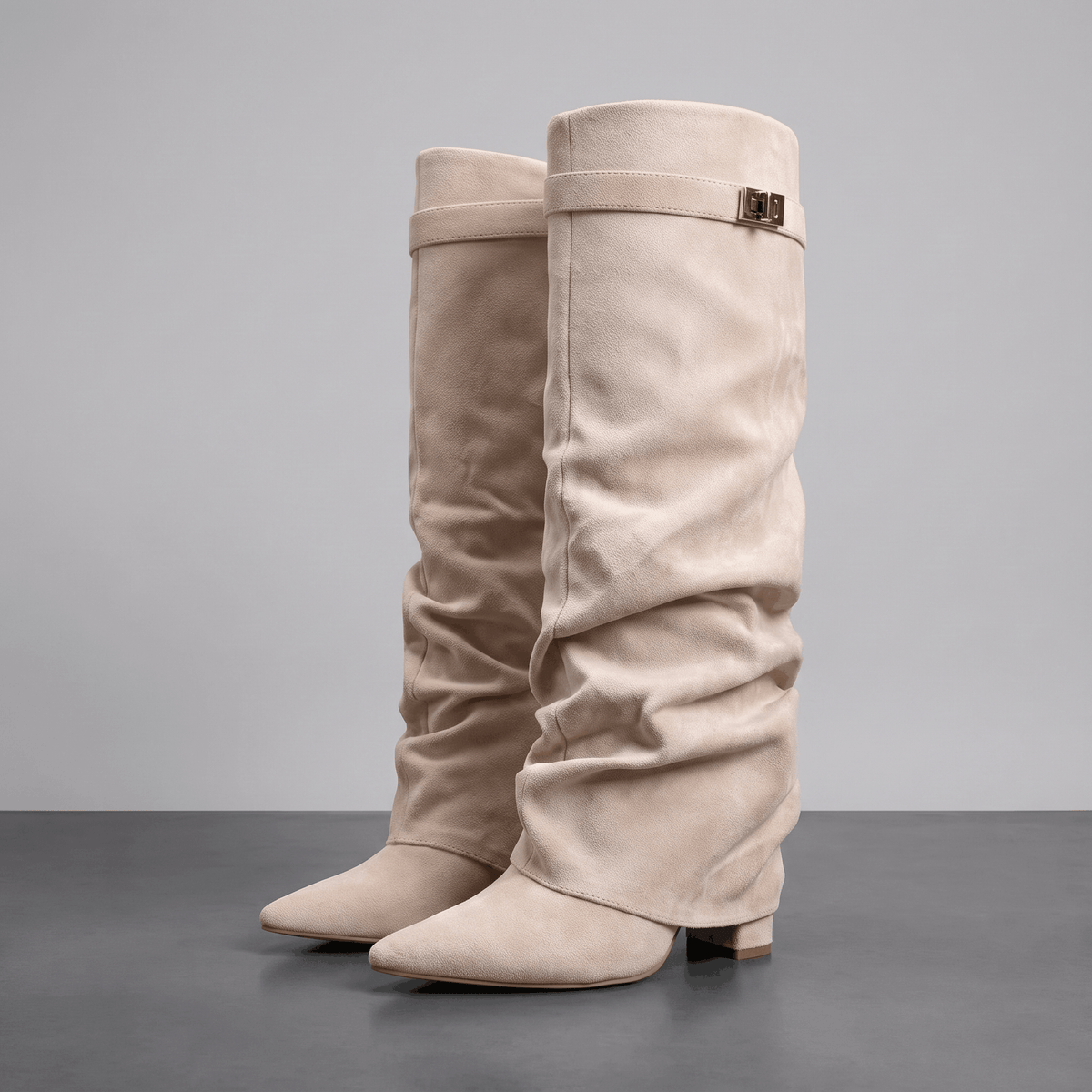 Beige fold-over knee-high boots shown from the side with pointed toes and strap detail