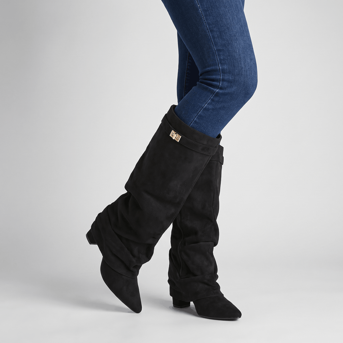 Black slouchy fold-over boots worn with blue jeans