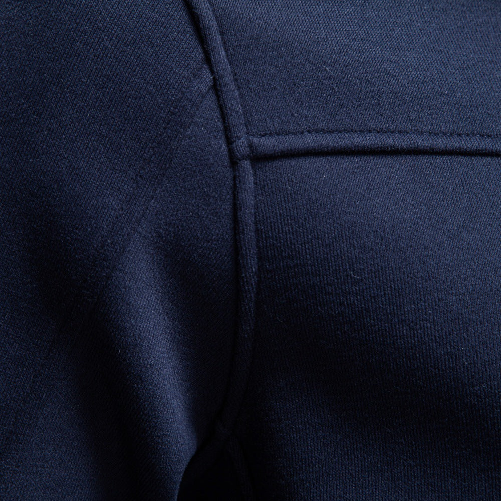 Close-up of navy sweatshirt showing chest seam detail