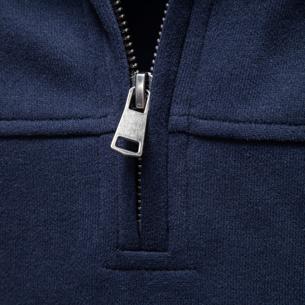 Close-up of navy sweatshirt showing zipper detail