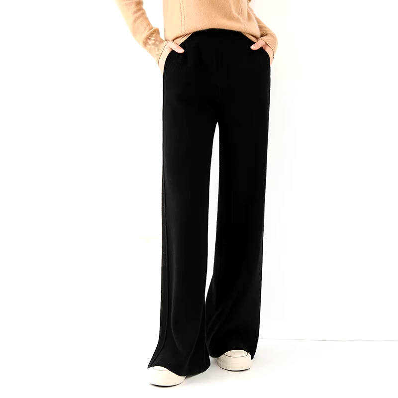Front view of a model wearing black straight-leg wool knit trousers with an elastic waistband and relaxed fit.