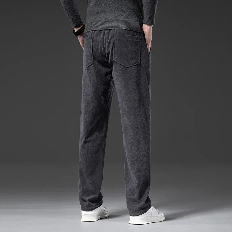 Charcoal gray stretch corduroy pants with a straight-leg fit, elastic drawstring waist, and back pockets.