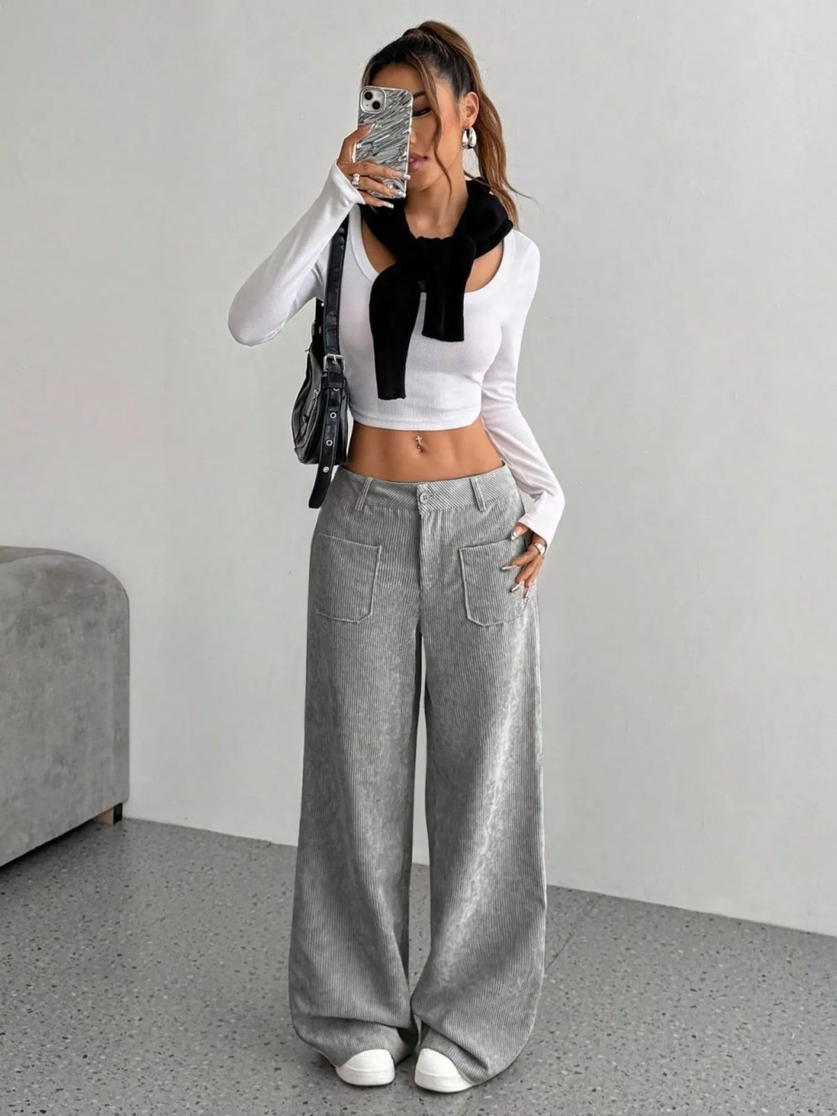 Gray wide-leg stretch corduroy pants with front patch pockets and a mid-rise waist, styled with a white cropped top.