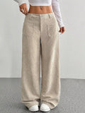 Beige stretch corduroy wide-leg pants featuring front patch pockets, a button-zip fly, and a relaxed floor-length fit.