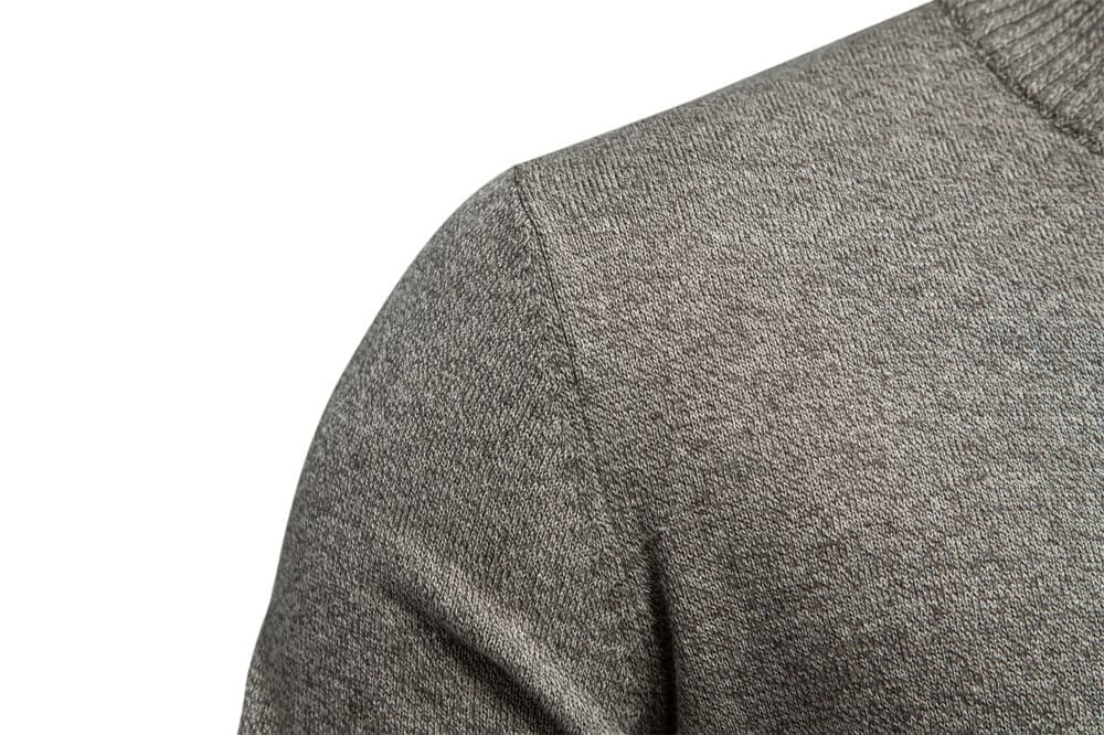 Close-up of a grey stretch cotton knit cardigan featuring a ribbed stand collar and soft, textured fabric.