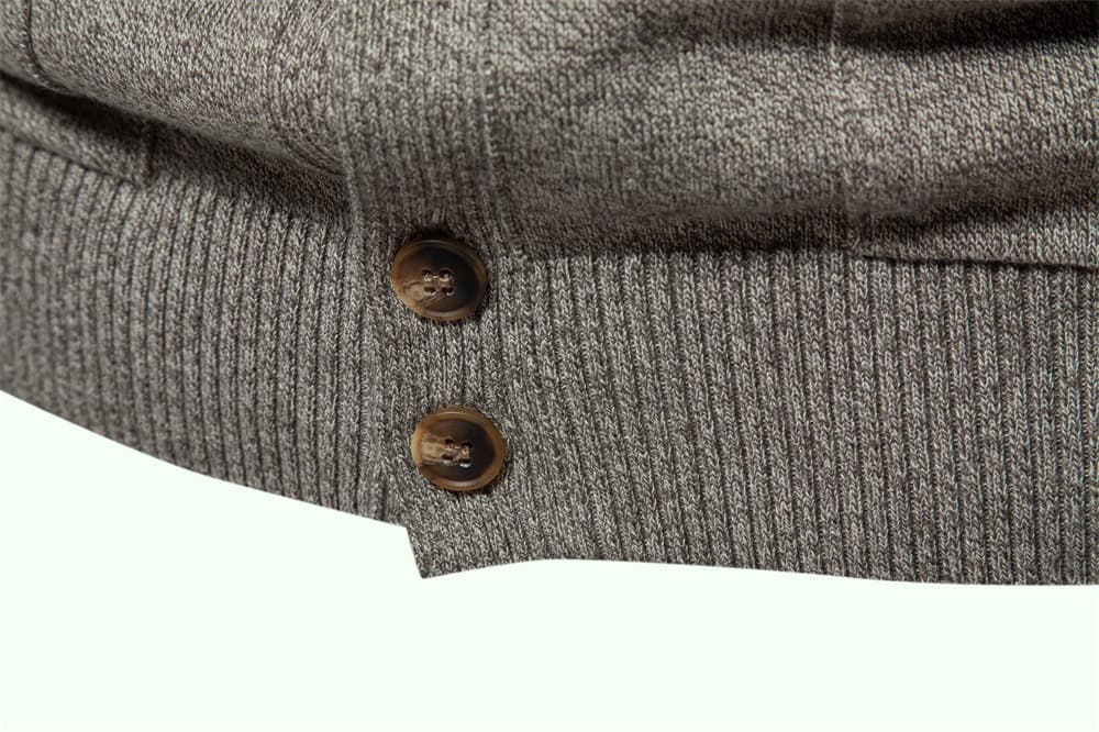 Grey stretch cotton knit cardigan featuring a ribbed hem and two brown buttons on a front placket.