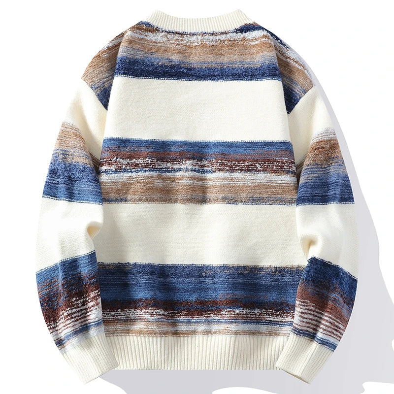 Soft knit cardigan featuring horizontal blue, brown, and cream stripes with ribbed cuffs and hem.