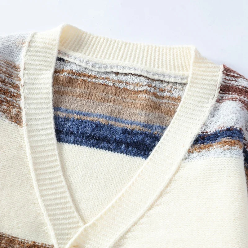 V-neck knit cardigan featuring a textured, rippled stripe pattern in cream, brown, and blue with ribbed trim details.