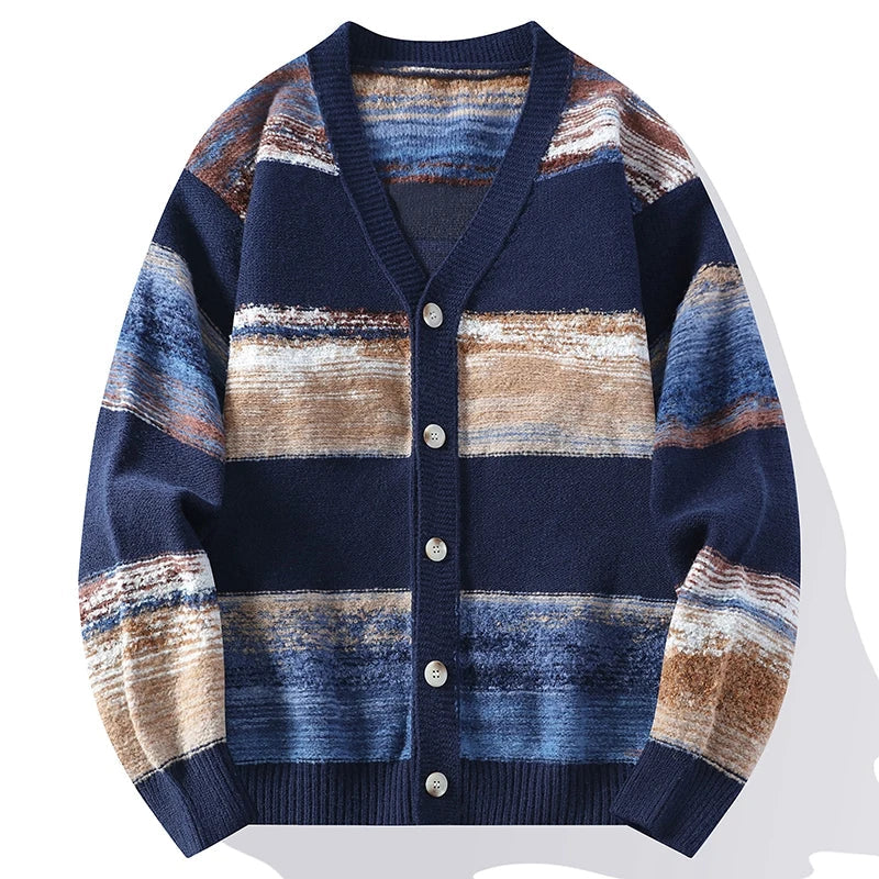 V-neck knit cardigan featuring a textured rippled stripe pattern in blue, tan, and white with a button-front closure.