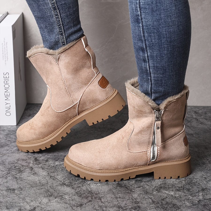 Beige fleece-lined suede ankle boots for women showing the side zip and lug sole tread