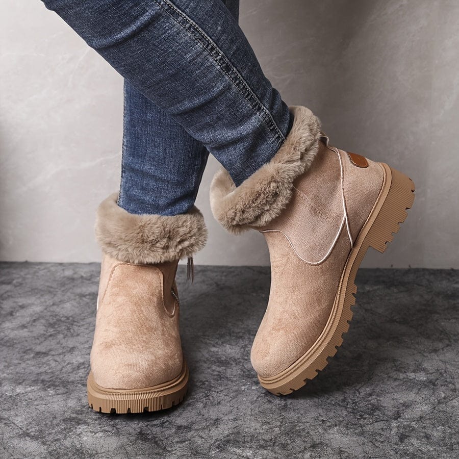 Beige suede ankle boots for women with plush fur collar and lug sole, worn with skinny jeans