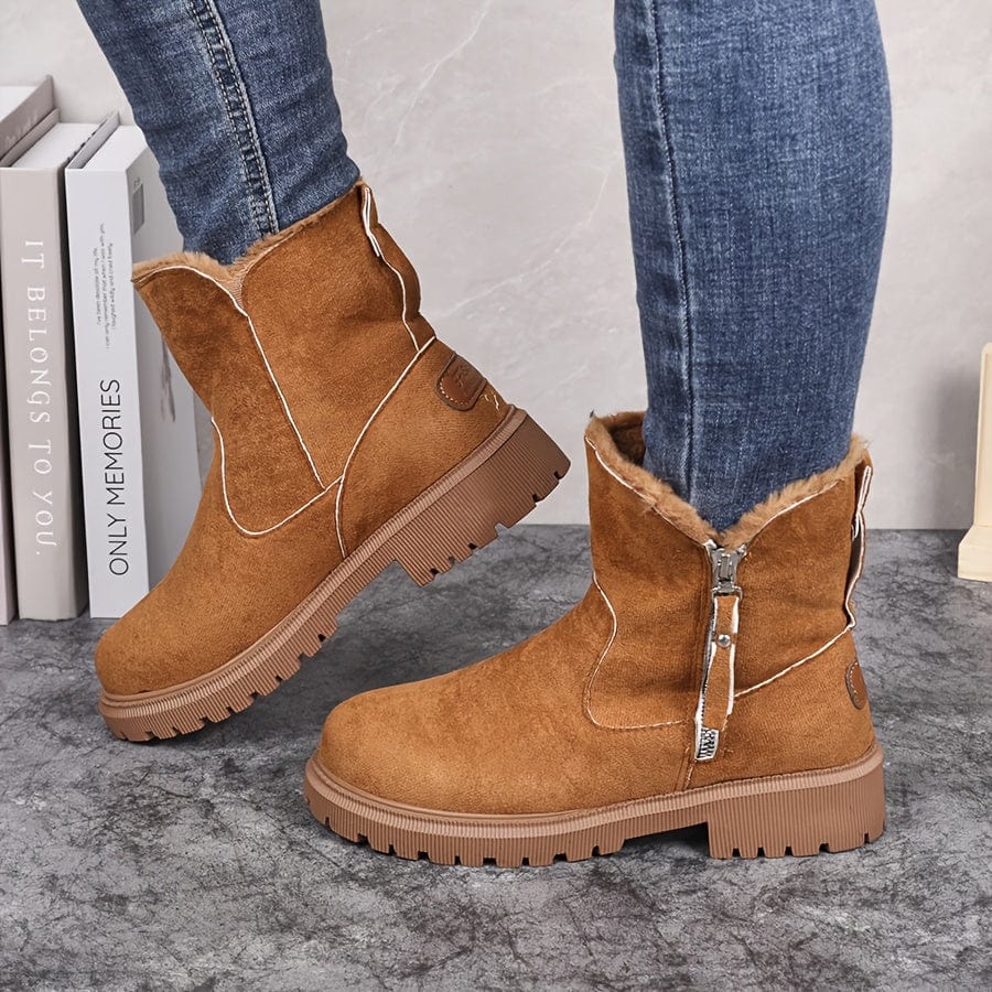 Brown suede ankle boots for women with fur-look collar and lug sole, worn with skinny jeans