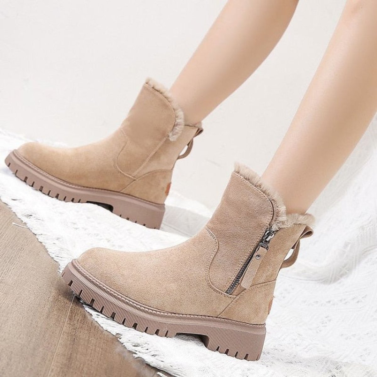 Close-up of beige suede platform ankle boots for women showing the fleece collar and side zip
