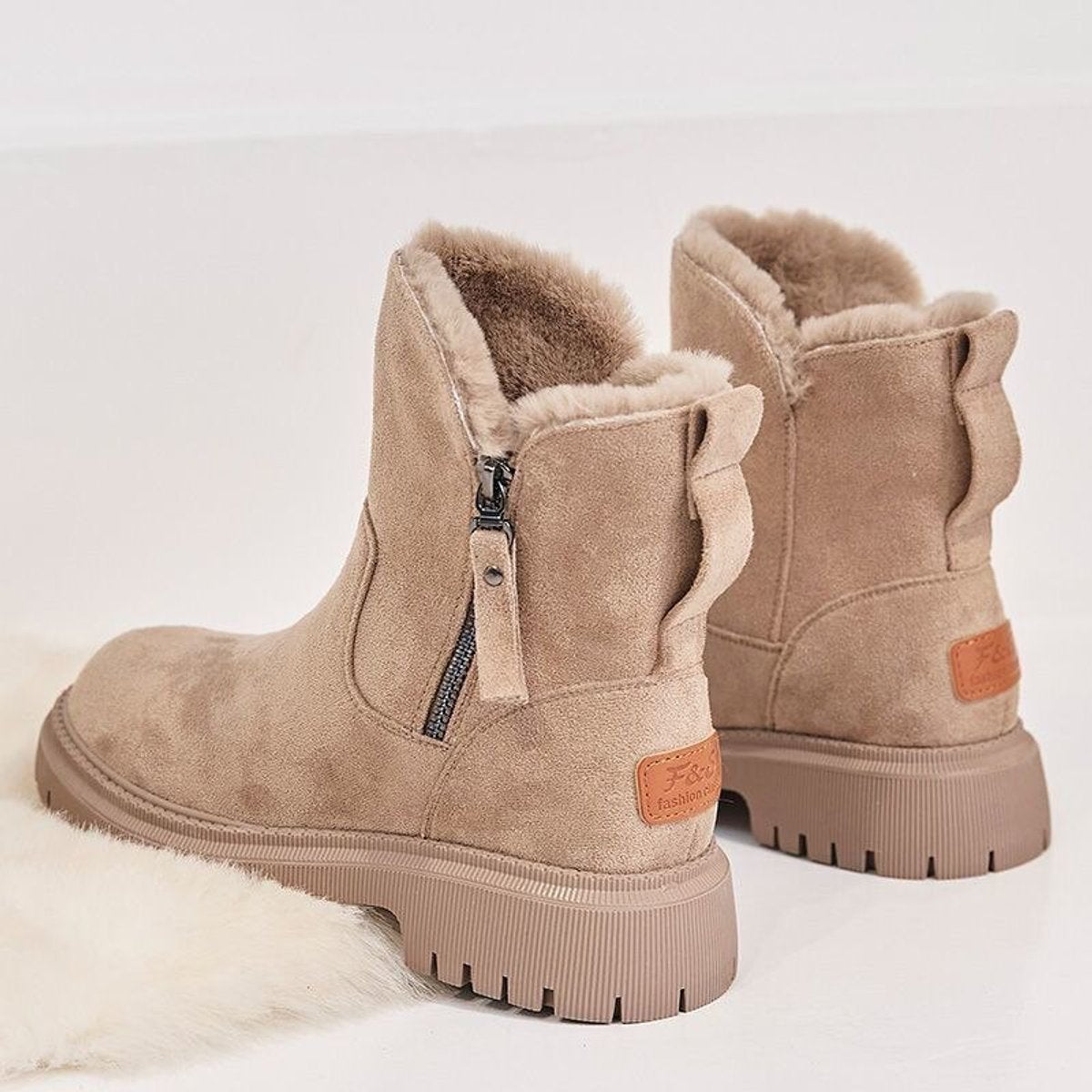 Pair of beige suede platform ankle boots for women with fleece lining and back pull loop