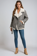 Gray suede aviator jacket with plush cream shearling lining, wide collar, side zip, and buckle strap details.