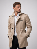 Beige Tailored Belted Trench Coat worn by a male model, featuring a single-breasted front, zip chest pocket, side pockets, and buckle cuff straps.