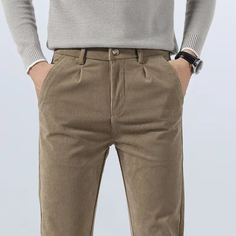Tan heavyweight corduroy pants with a straight-leg fit, featuring a clean zip-fly front and textured ribbed cotton fabric.