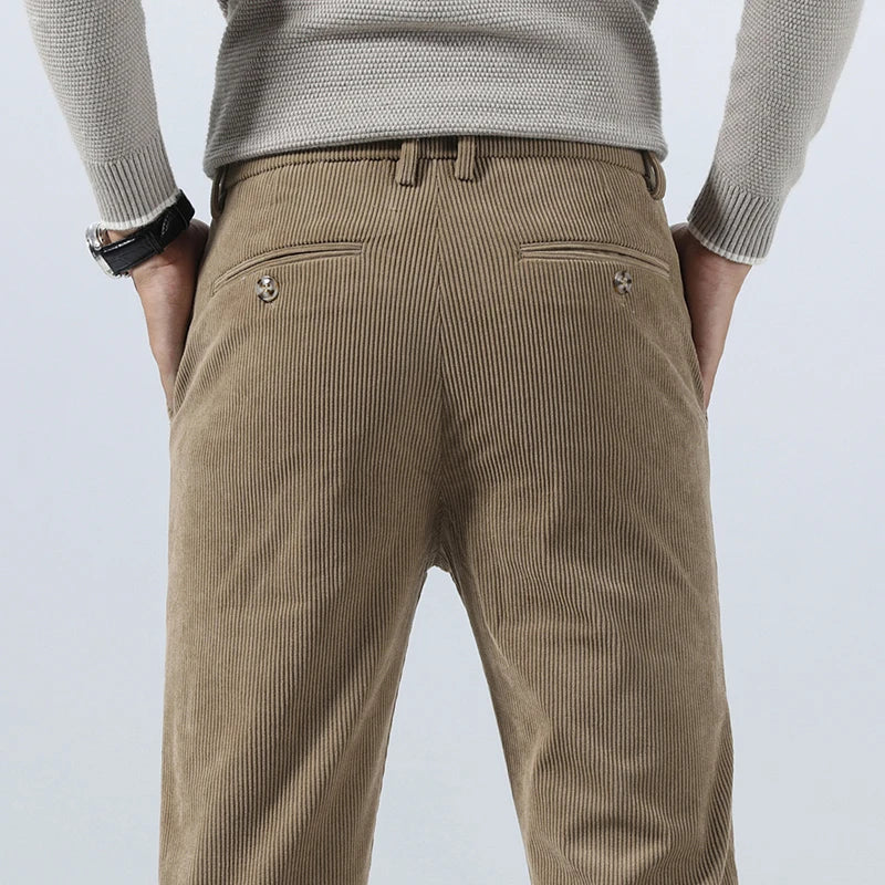Tailored tan corduroy pants in a heavyweight cotton blend featuring a straight-leg fit and buttoned back welt pockets.