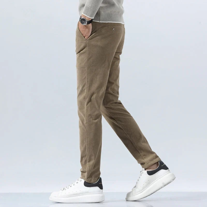 Tailored tan corduroy pants in a straight-leg fit, featuring a heavyweight ribbed texture and clean, sharp seams.