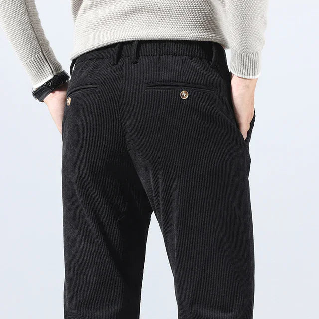 Black heavyweight corduroy pants with a straight-leg fit, featuring rear welt pockets and a tailored waistband.