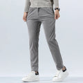 Gray heavyweight corduroy pants in a straight-leg fit with a clean zip-fly, styled with a sweater and white sneakers.