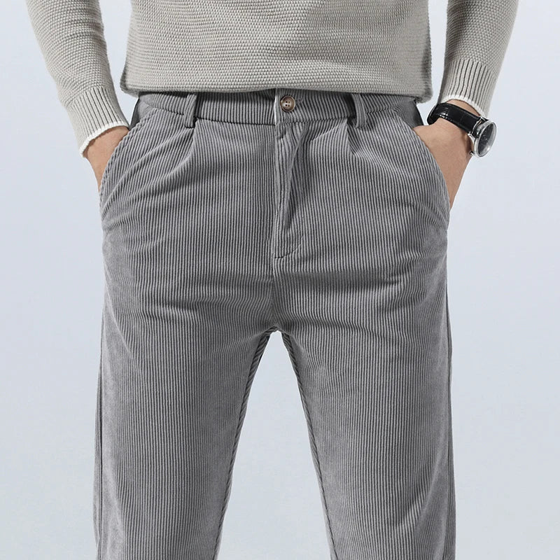 Gray straight-fit corduroy pants in heavyweight cotton with a clean zip-fly front and textured ribbed finish.