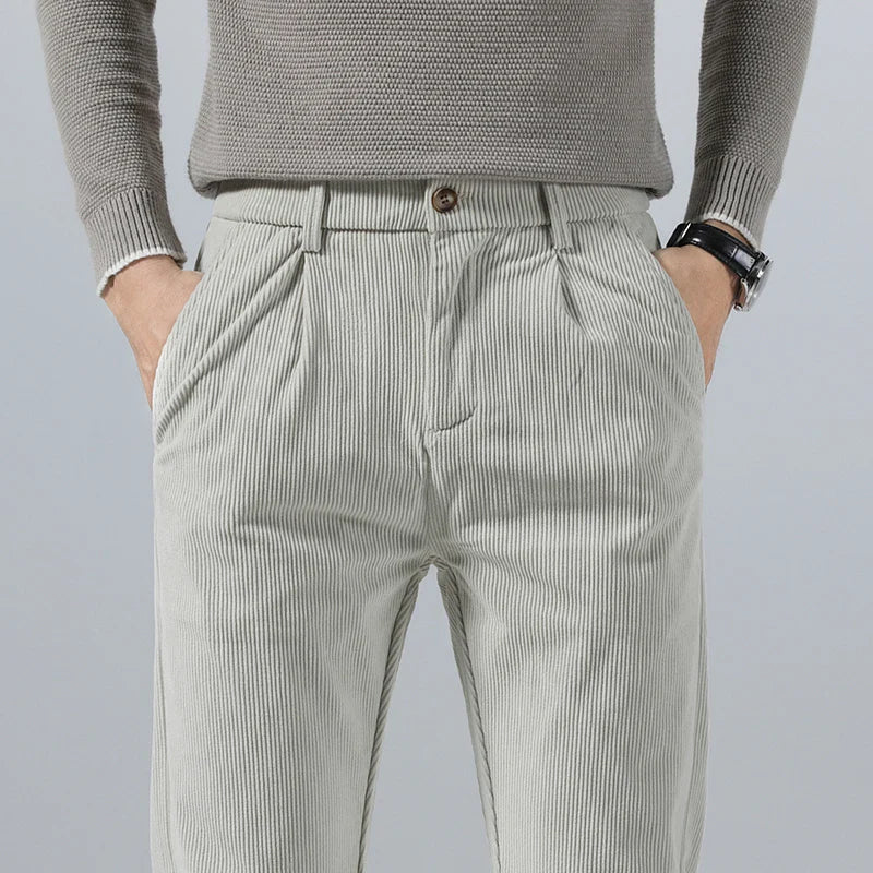 Light gray heavyweight corduroy pants with a straight-leg fit, featuring a clean zip-fly front and textured ribbed fabric.
