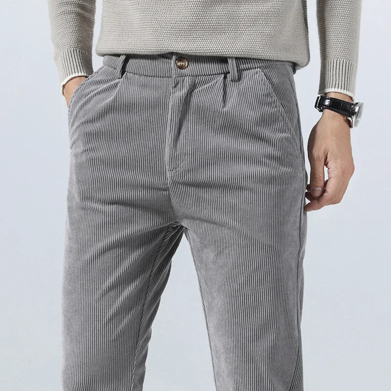 Gray heavyweight corduroy pants with a straight-leg fit, featuring a clean zip-fly and tailored waistband.