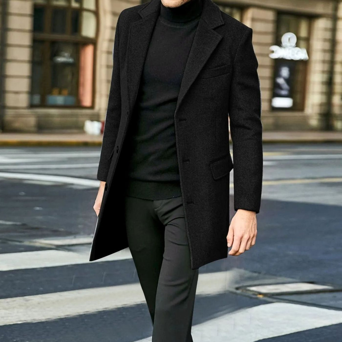 Black Tailored Single-Breasted Overcoat worn by a male model outdoors, featuring notch lapels, a button front, flap pockets, and a longline silhouette.