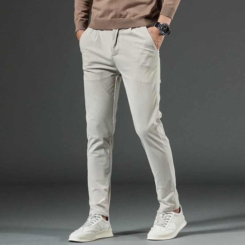 Light gray tapered corduroy pants styled with a casual sweater and sneakers
