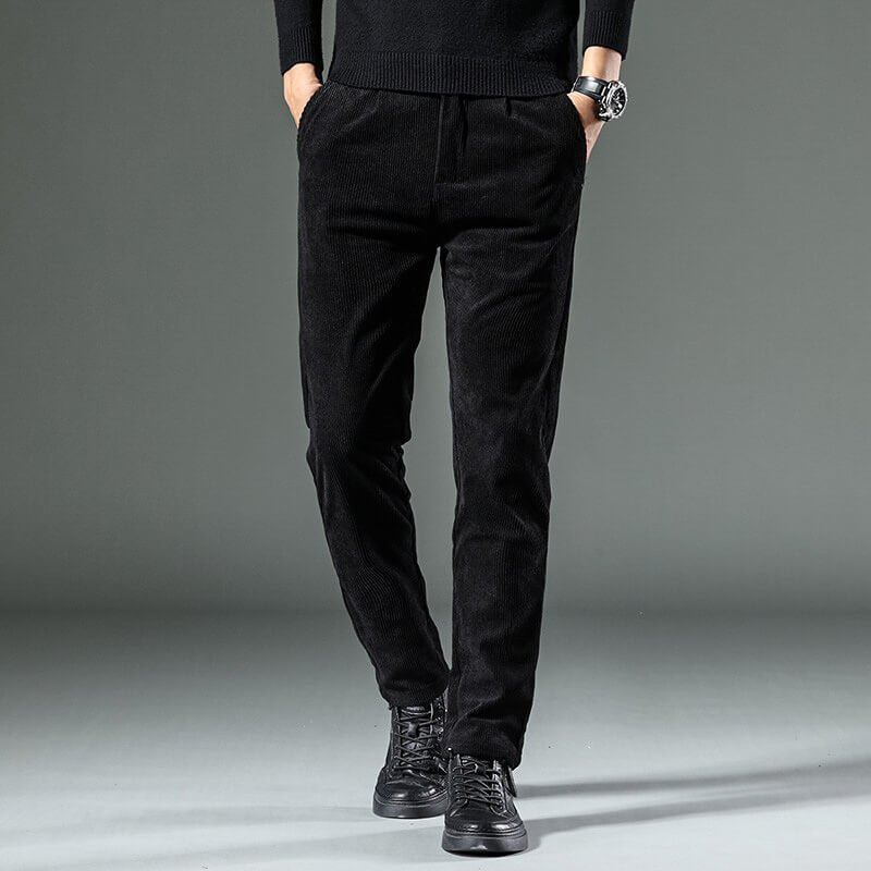 Black tapered corduroy pants with a smooth finish and front pockets