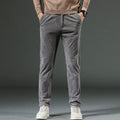 Gray tapered fine-wale corduroy pants with a smooth finish and front pockets