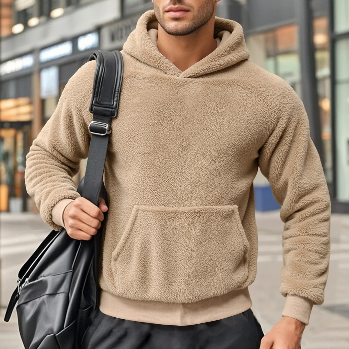 Beige teddy fleece hoodie worn by a male model, shown from the front with a kangaroo pocket.