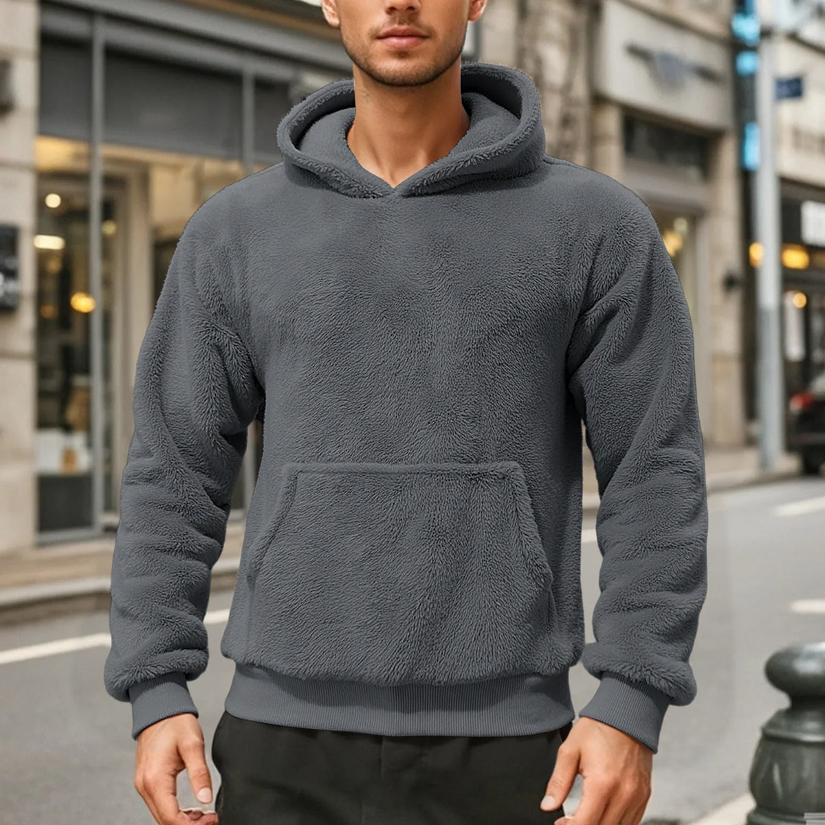 Gray teddy fleece hoodie worn by a male model, shown from the front with a kangaroo pocket.