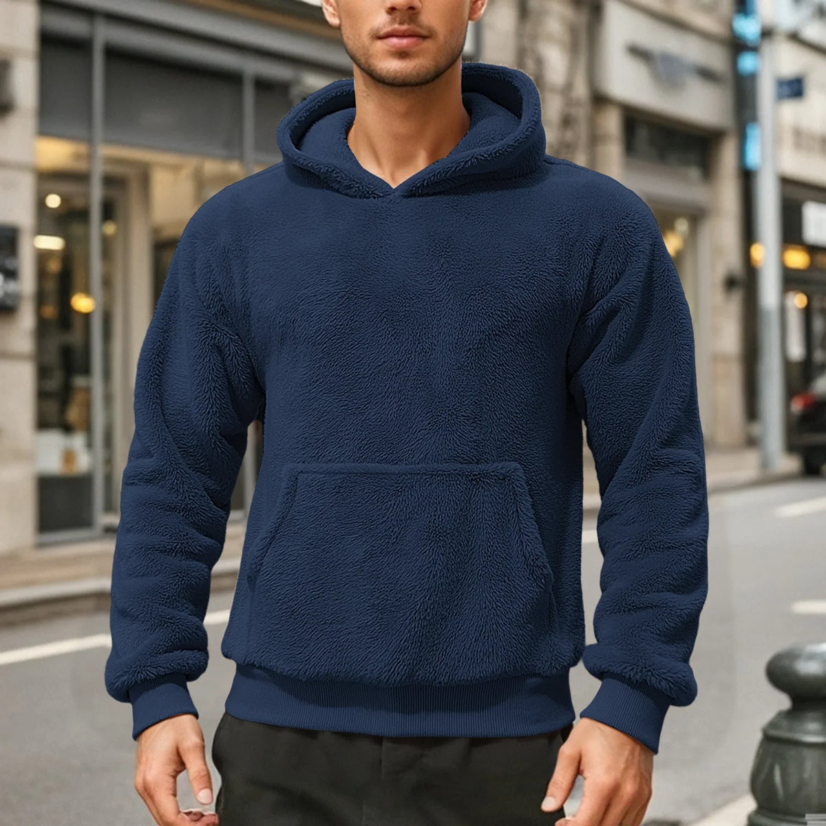 Navy blue teddy fleece hoodie worn by a male model, shown from the front with a kangaroo pocket.