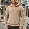 Beige teddy fleece hoodie worn by a male model, featuring a kangaroo pocket, hood, ribbed cuffs, and relaxed fit.