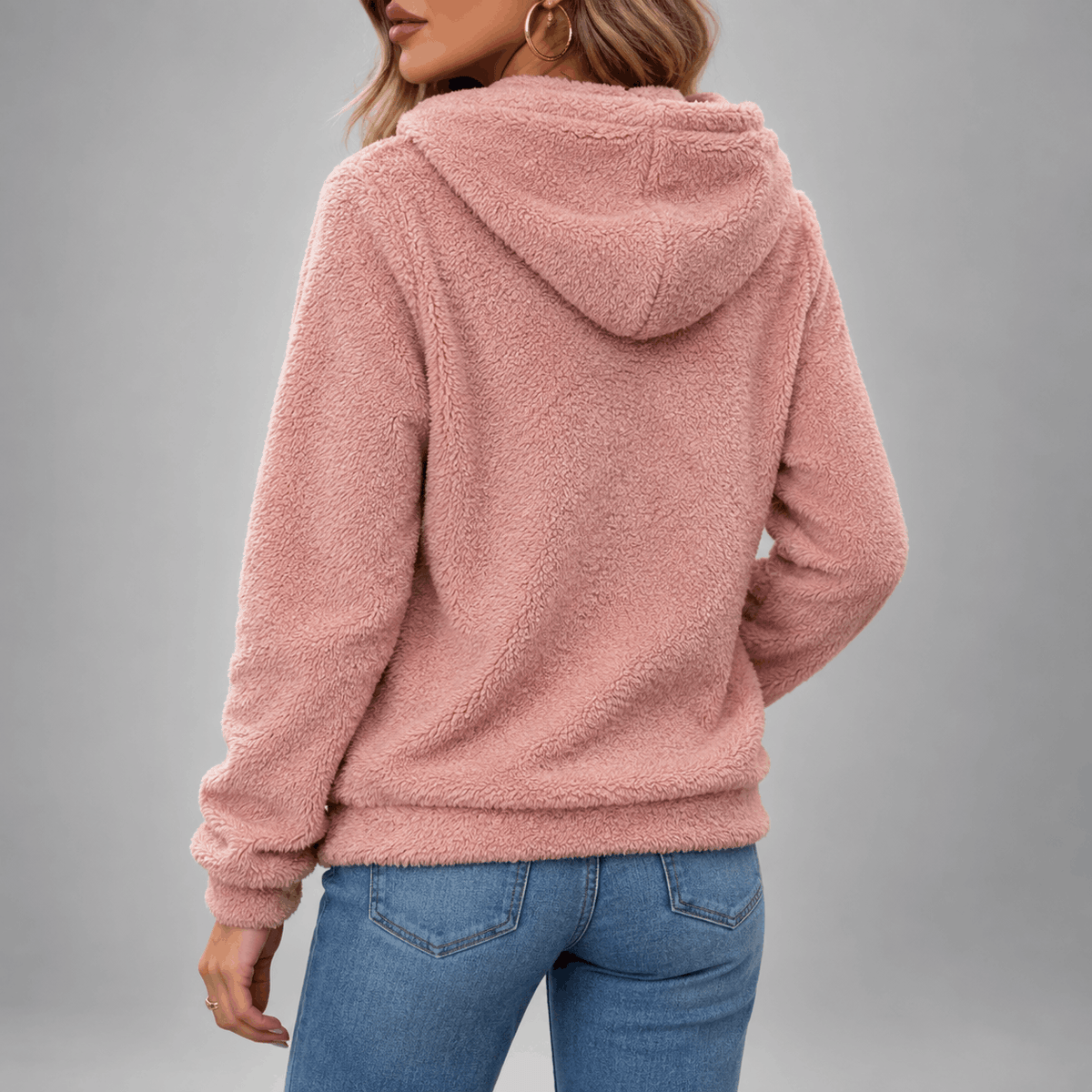 Teddy Fleece Pullover Hoodie – Pink hoodie shown from the back on a female model with a hood and relaxed fit