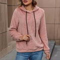 Teddy Fleece Pullover Hoodie – Pink hoodie worn by a female model with drawstrings and kangaroo pocket