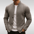 Gray textured knit cardigan with a mandarin collar, button front, and flat patch pockets worn over a white crew-neck tee.
