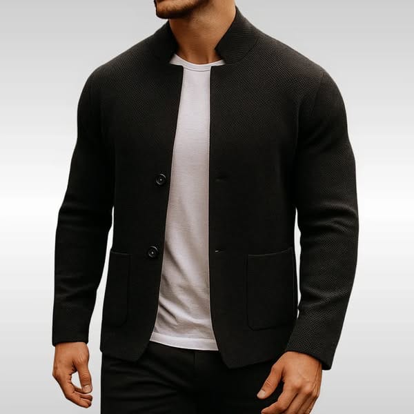 Black textured knit cardigan with a mandarin collar, two-button front, and flat patch pockets worn over a white tee.