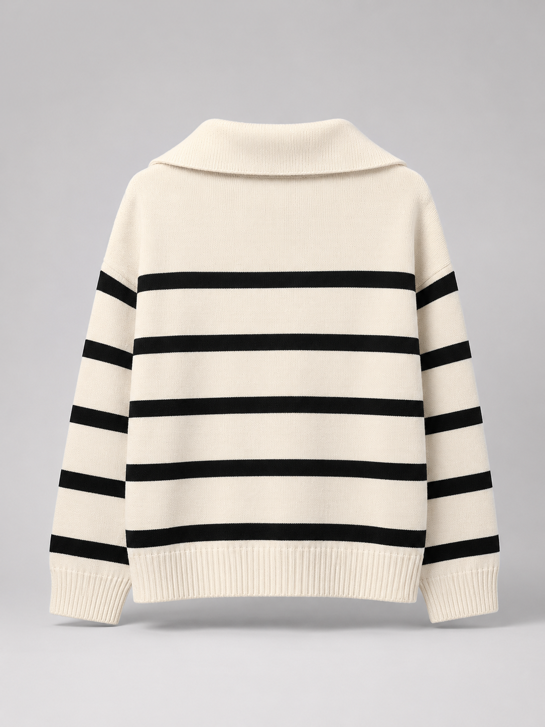 Cream and black striped mid-weight knit sweater with a relaxed drop-shoulder fit, stand collar, and ribbed hem.