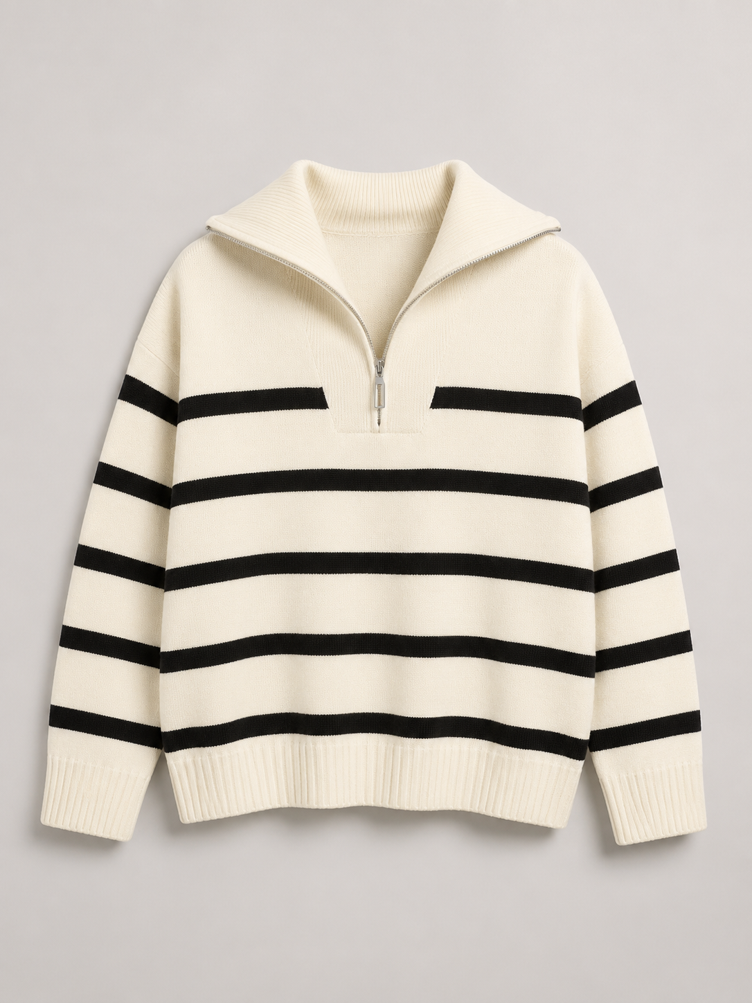 Cream and black striped half-zip sweater in a mid-weight knit with a relaxed drop-shoulder fit and ribbed trim.