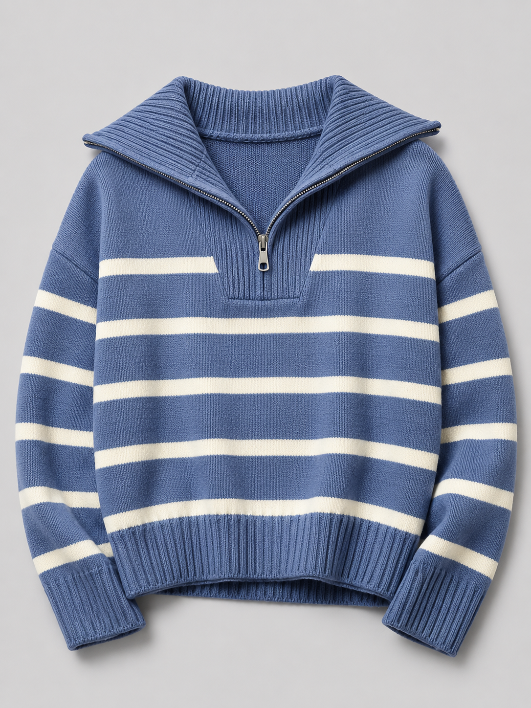 Blue and white striped mid-weight knit sweater with a half-zip stand collar, drop shoulders, and ribbed trim.